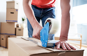 person packing up a box